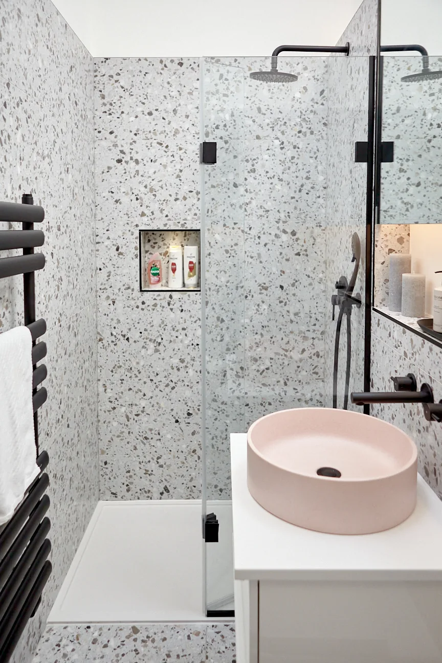 Pink round concrete basin in a terrazzo shower room